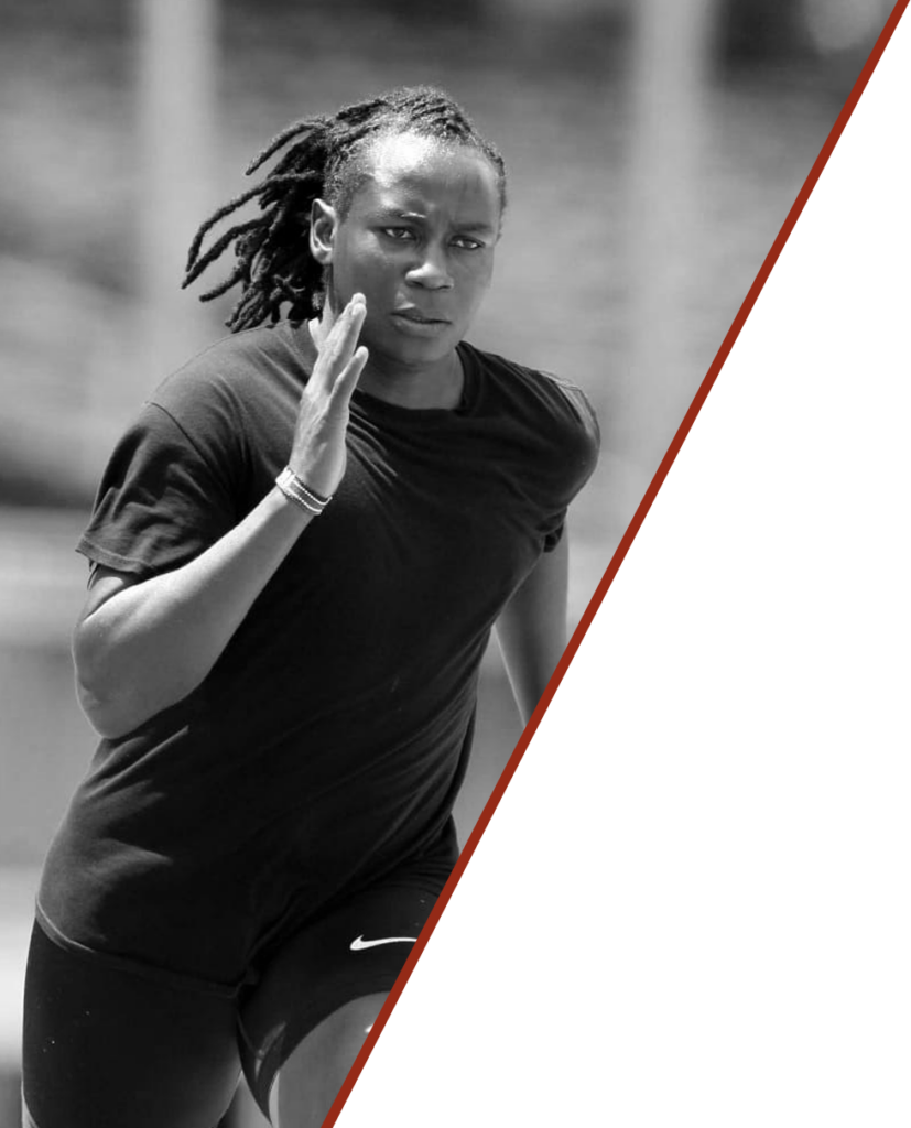 Black and white photo of a sprinter in full stride on a track